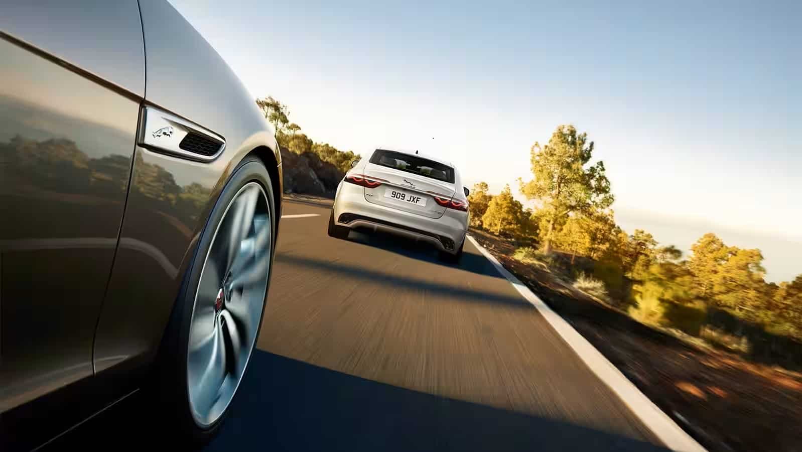 Yulong White and Carpathian Grey driving on road.