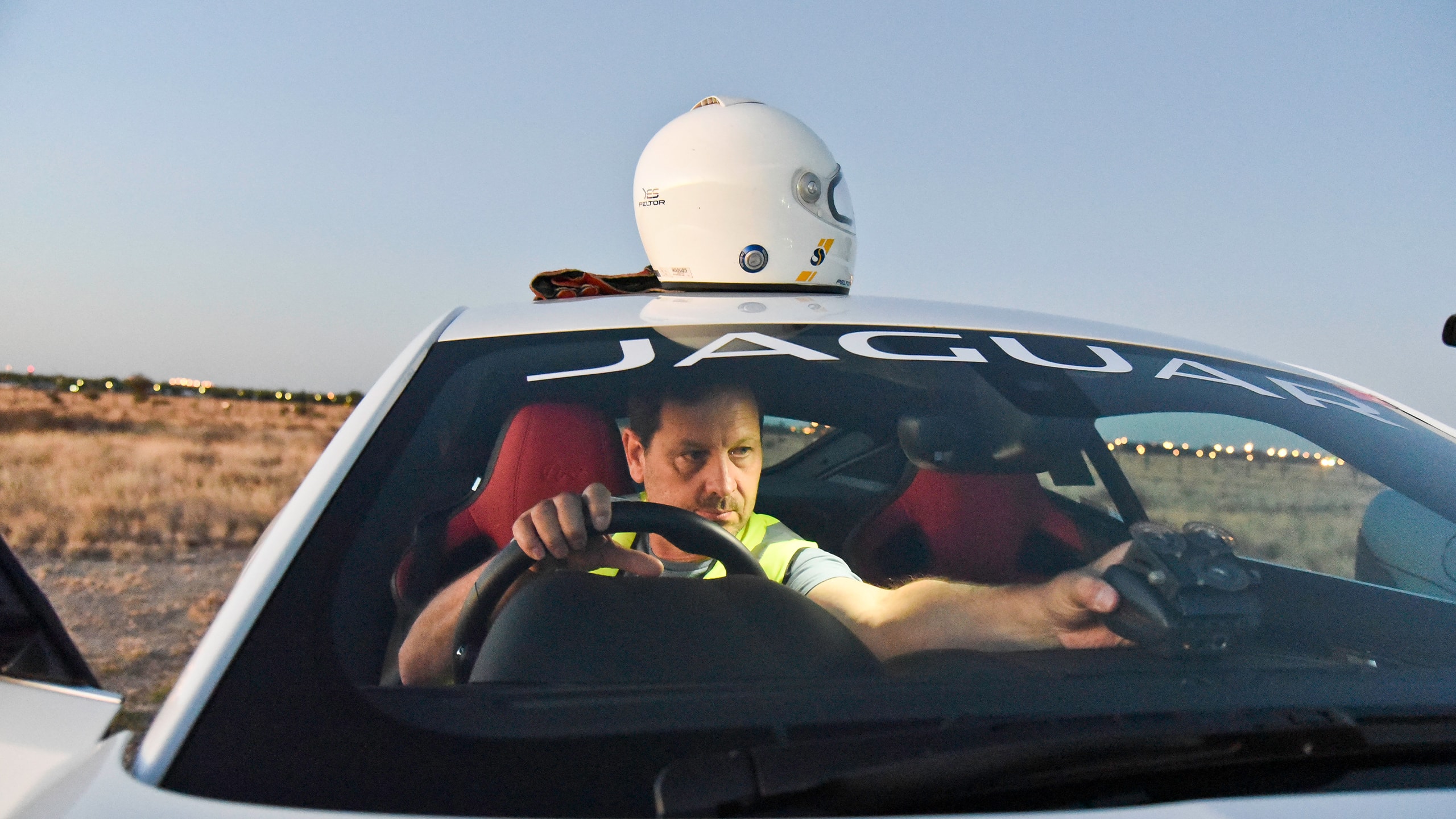 A person setting camera in racing car