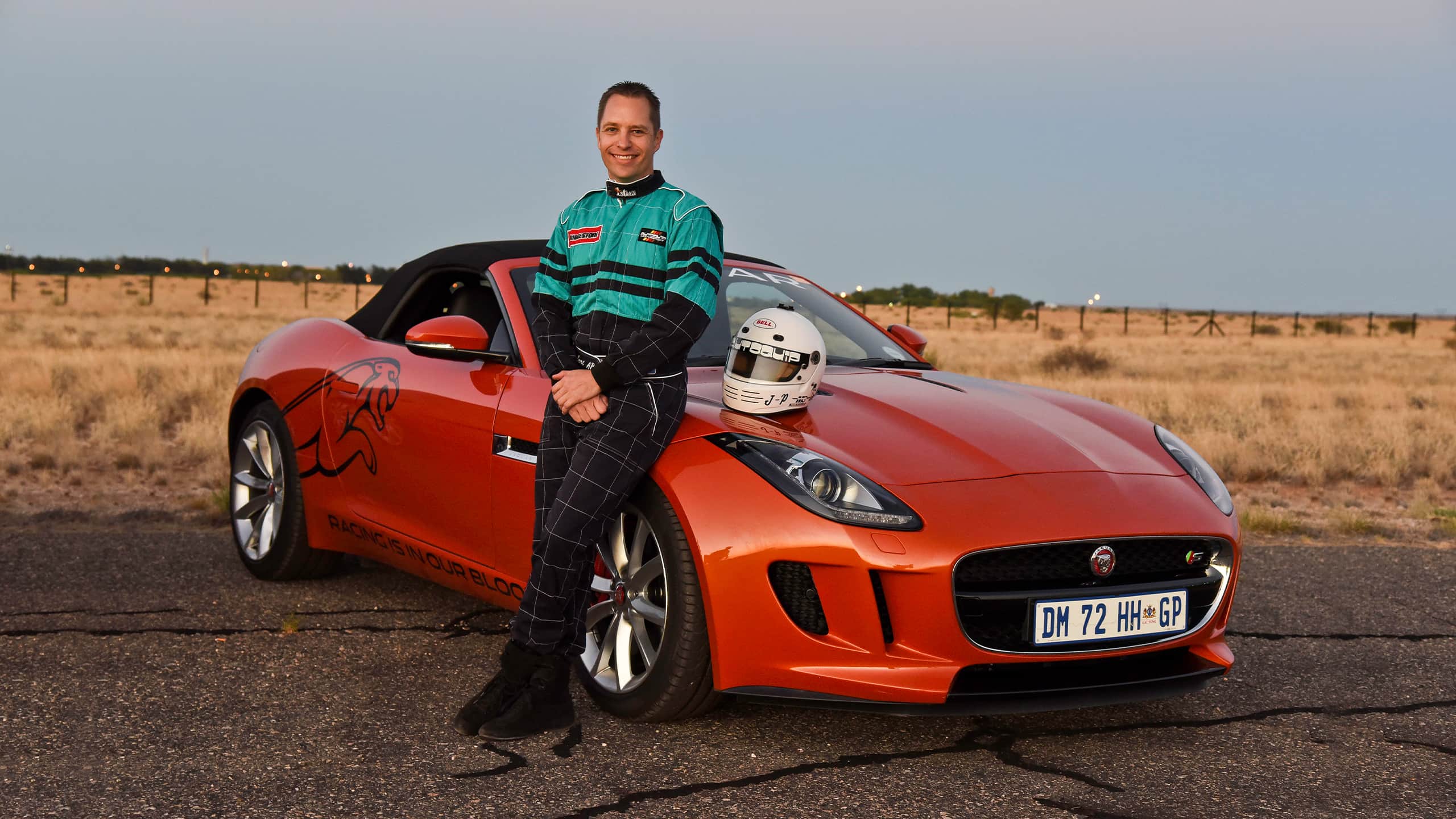 A person standing beside Jaguar F Type